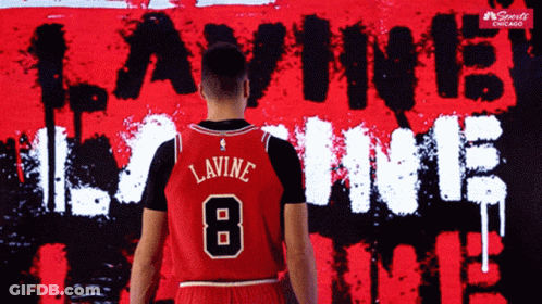 A Basketball Player Stands In Front Of A Wall That Says Lavine 8 GIF