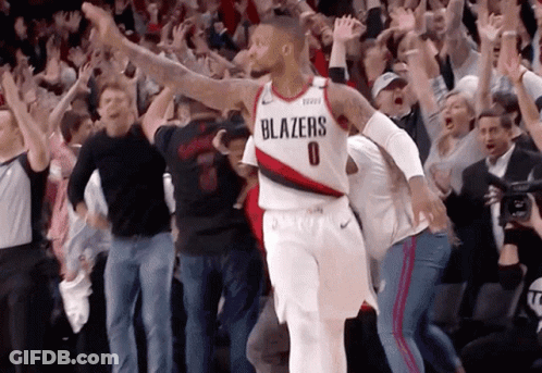 A Basketball Player Wearing A Blazers Jersey Is Surrounded By Fans GIF