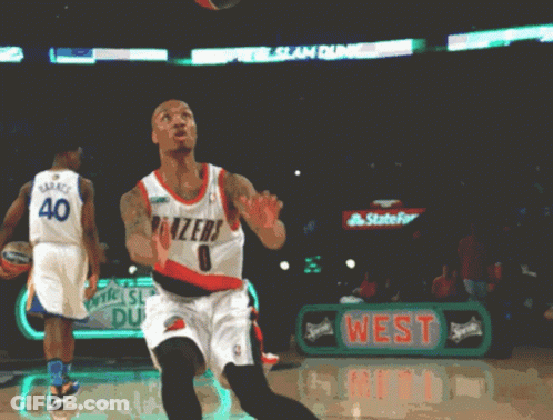 A Basketball Player Wearing A Blazers Jersey Throws The Ball GIF