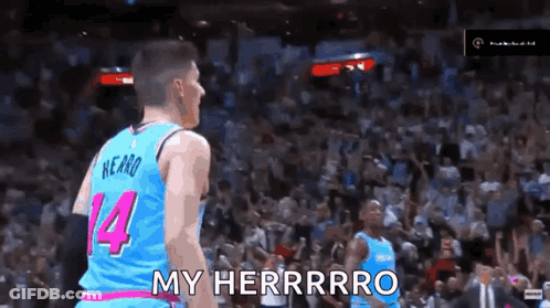 A Basketball Player Wearing A Blue And Pink Jersey With The Number 14 On It GIF