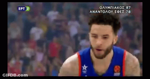 A Basketball Player Wearing A Blue And Red Jersey With A Star On It Is Standing On A Court . GIF