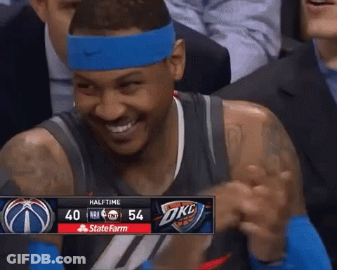 A Basketball Player Wearing A Blue Headband Is Smiling In Front Of A Scoreboard That Says Halftime At The Top GIF