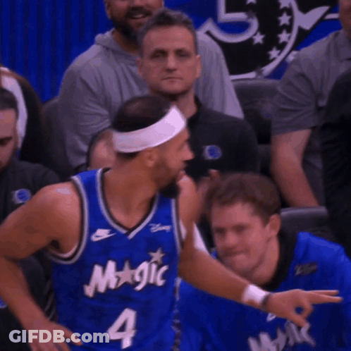 A Basketball Player Wearing A Blue Jersey That Says Magic On It GIF