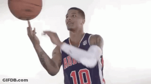 A Basketball Player Wearing A Blue Jersey With The Number 10 On It Is Spinning A Basketball On His Finger . GIF