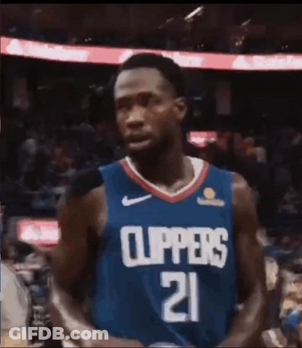 A Basketball Player Wearing A Blue Jersey With The Number 21 On It . GIF