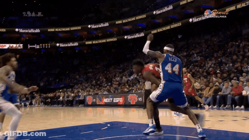 A Basketball Player Wearing A Blue Jersey With The Number 44 On The Back GIF