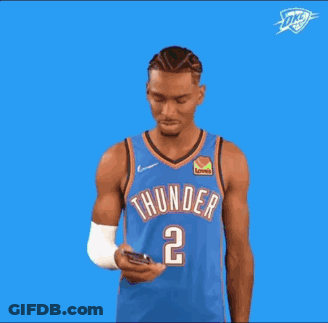 A Basketball Player Wearing A Blue Thunder Jersey Is Pointing Up . GIF