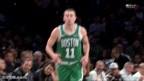 A Basketball Player Wearing A Boston 11 Jersey Stands In Front Of A Crowd GIF