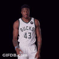 A Basketball Player Wearing A Bucks Jersey Holds His Hands To His Head GIF