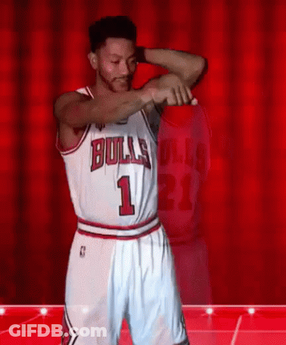 A Basketball Player Wearing A Bulls Jersey And Shorts Is Dancing On A Stage . GIF