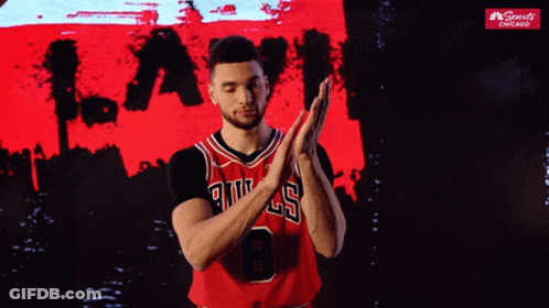 A Basketball Player Wearing A Bulls Jersey Clapping His Hands GIF