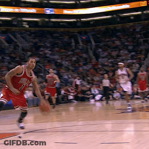 A Basketball Player Wearing A Bulls Jersey Is Dribbling The Ball GIF