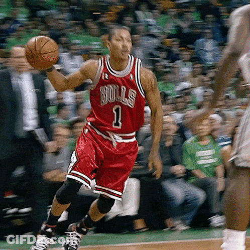 A Basketball Player Wearing A Bulls Jersey Is Holding A Basketball GIF