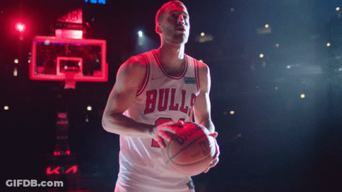 A Basketball Player Wearing A Bulls Jersey Is Holding A Basketball GIF