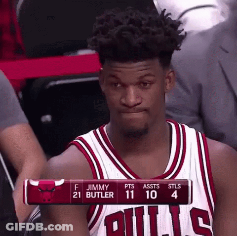 A Basketball Player Wearing A Bulls Jersey Is Sitting In The Stands . GIF