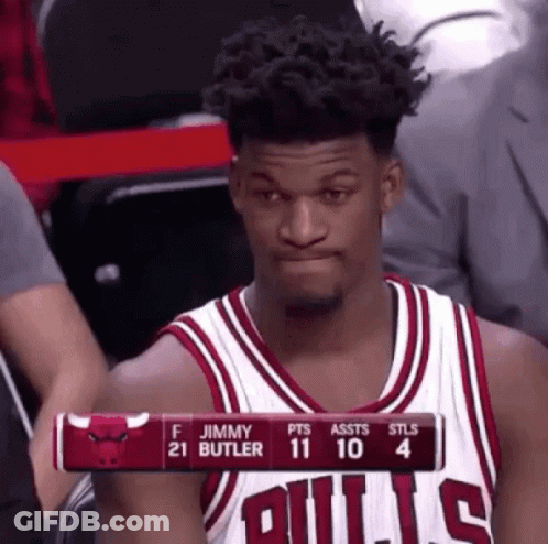 A Basketball Player Wearing A Bulls Jersey Is Sitting In The Stands Watching A Game . GIF