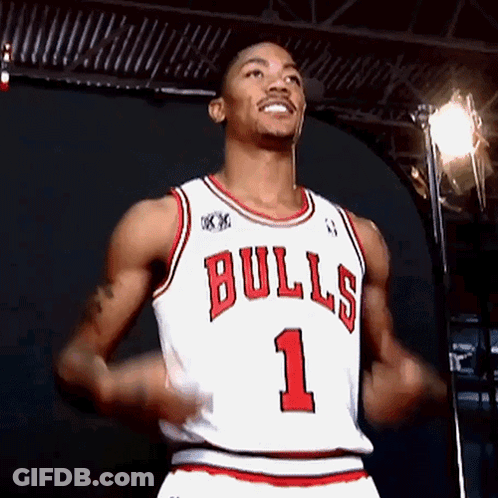 A Basketball Player Wearing A Bulls Jersey Is Smiling GIF