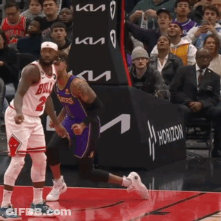 A Basketball Player Wearing A Bulls Jersey Runs Towards Another Player Wearing A Lakers Jersey GIF