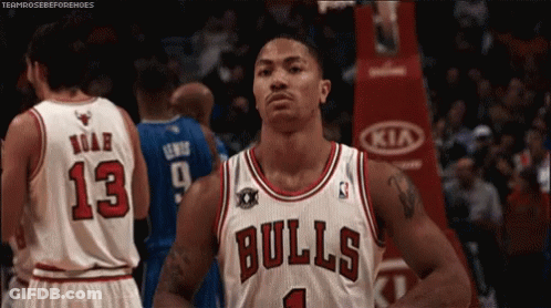 A Basketball Player Wearing A Bulls Jersey Stands In Front Of A Crowd GIF