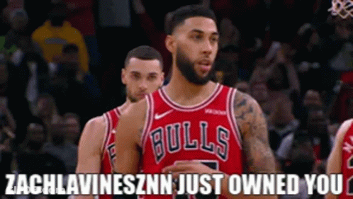 A Basketball Player Wearing A Bulls Jersey Stands Next To Another Player . GIF