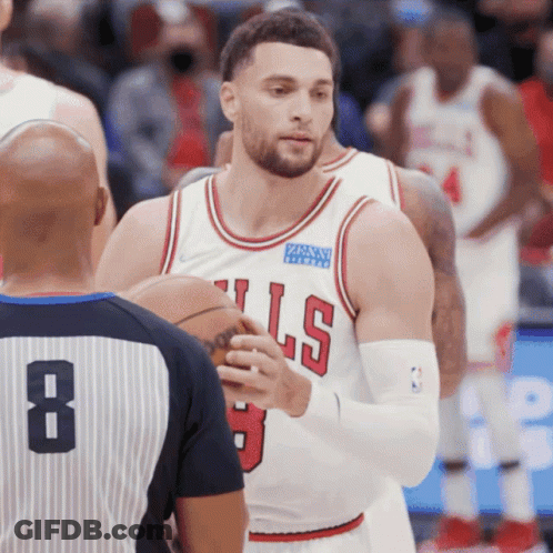 A Basketball Player Wearing A Bulls Jersey Talks To A Referee GIF