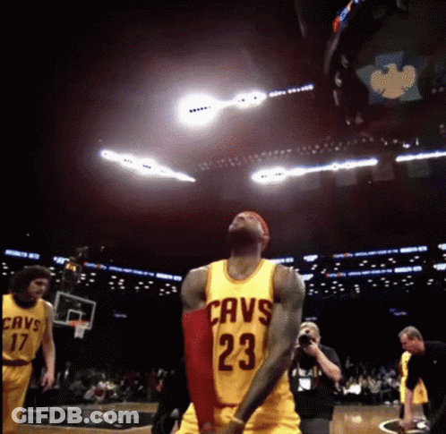 A Basketball Player Wearing A Cavs Jersey Is Jumping In The Air GIF