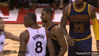 A Basketball Player Wearing A Cavs Jersey Is Talking To Another Player GIF