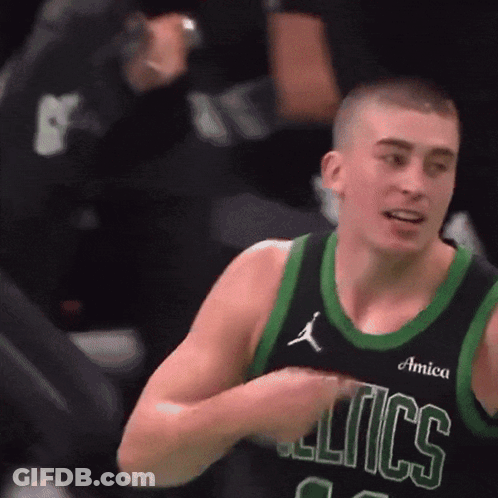 A Basketball Player Wearing A Celtics Jersey Holds His Hands To His Chest GIF