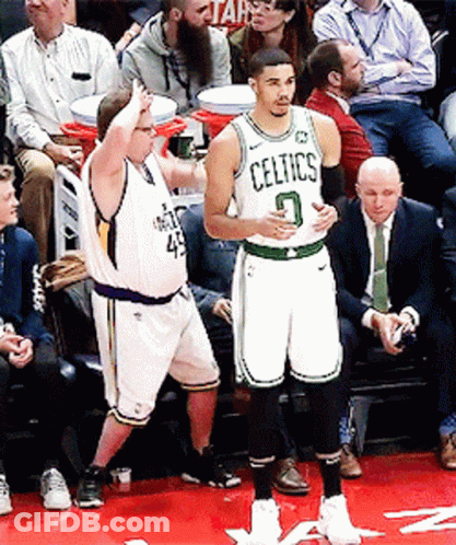 A Basketball Player Wearing A Celtics Jersey Stands On A Court GIF