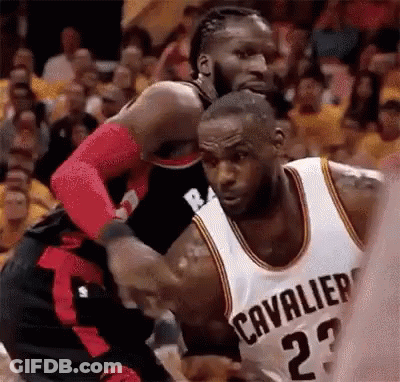 A Basketball Player Wearing A Cleveland Cavaliers Jersey Is Fighting Another Player . GIF