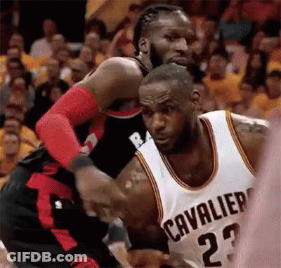 A Basketball Player Wearing A Cleveland Cavaliers Jersey Is Fighting Another Player On The Court . GIF