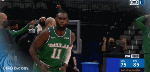 A Basketball Player Wearing A Dallas 11 Jersey Is Celebrating GIF