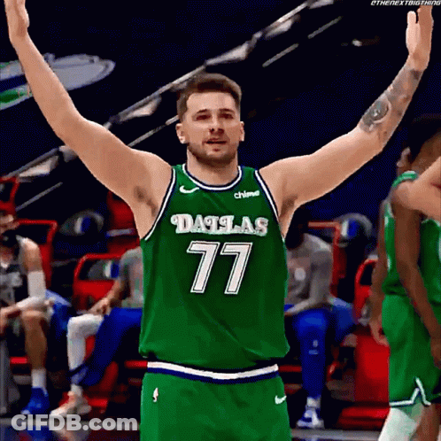 A Basketball Player Wearing A Dallas 77 Jersey With His Arms Outstretched GIF