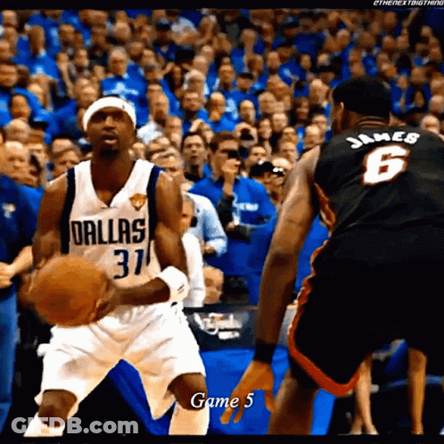 A Basketball Player Wearing A Dallas Jersey Holds The Ball GIF