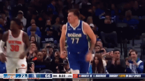 A Basketball Player Wearing A Dallas Jersey Is Running On The Court GIF