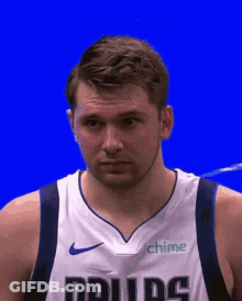 A Basketball Player Wearing A Dallas Jersey With A Blue Background GIF