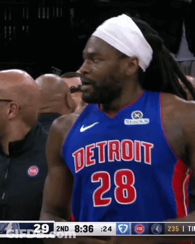 A Basketball Player Wearing A Detroit 28 Jersey Is Eating Something GIF