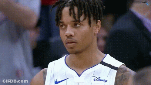 A Basketball Player Wearing A Disney Jersey Looks At The Camera GIF