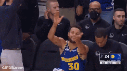 A Basketball Player Wearing A Golden State Warriors Jersey Is Clapping His Hands GIF