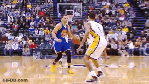 A Basketball Player Wearing A Golden State Warriors Jersey Is Dribbling A Ball GIF