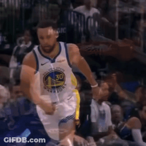 A Basketball Player Wearing A Golden State Warriors Jersey Is Dribbling The Ball GIF