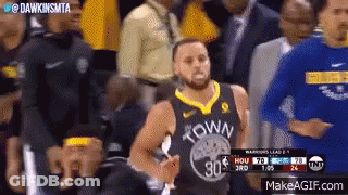 A Basketball Player Wearing A Golden State Warriors Jersey Is Standing In Front Of A Crowd Of People . GIF