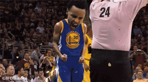 A Basketball Player Wearing A Golden State Warriors Jersey Is Standing In Front Of A Referee With His Mouth Open . GIF