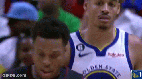 A Basketball Player Wearing A Golden State Warriors Jersey Is Standing Next To Another Basketball Player . GIF