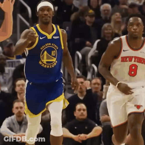 A Basketball Player Wearing A Golden State Warriors Jersey Runs Past Another Player Wearing A New York Knicks Jersey GIF