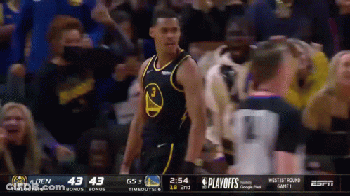 A Basketball Player Wearing A Golden State Warriors Jersey Stands In Front Of A Crowd . GIF