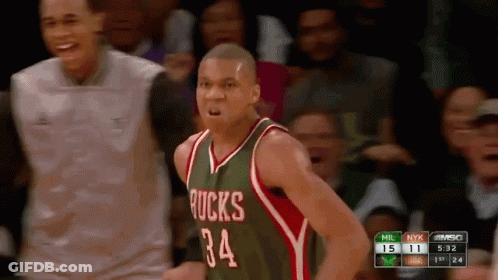 A Basketball Player Wearing A Green And Red Jersey With The Number 34 GIF