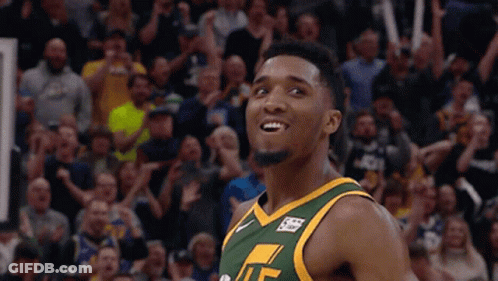 A Basketball Player Wearing A Green And Yellow Jersey With The Letter T On It GIF