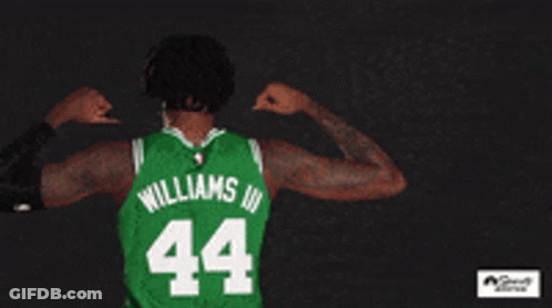 A Basketball Player Wearing A Green Boston Jersey GIF