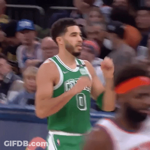 A Basketball Player Wearing A Green Jersey Is Running On The Court During A Game . GIF